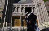 A Hasidic Jew walks past a closed synagogue in the Borough Park section of Brooklyn, one of the five boroughs of New York City, on October 9, 2020.  (Angela Weiss / AFP)