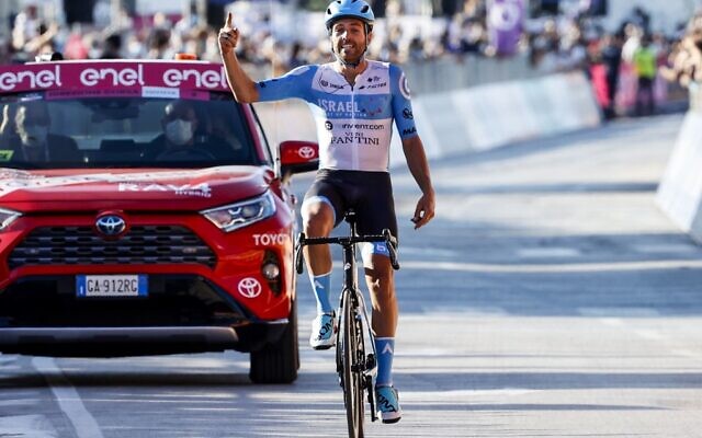 Team Israel Start-Up Nation rider England's Alex Dowsett celebrates as he crosses the line for victory during the 8th stage of the Giro d'Italia 2020 cycling race, a 200-kilometer route between Giovinazzo and Vieste on October 10, 2020. (Luca Bettini / AFP) Team Israel Start-Up Nation rider England's Alex Dowsett celebrates as he crosses the line for victory during the 8th stage of the Giro d'Italia 2020 cycling race, a 200-kilometer route between Giovinazzo and Vieste on October 10, 2020. (Luca Bettini / AFP)