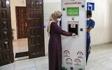 Palestinian entrepreneur Heba al-Hindi demonstrates a locally designed and manufactured smart sterilization device in Gaza City on October 8, 2020, as the machine is to be to be deployed across various facilities in the Gaza Strip as part of efforts to curb the spread of COVID-19 coronavirus disease (MOHAMMED ABED / AFP)
