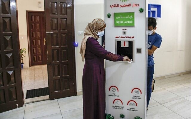 Palestinian entrepreneur Heba al-Hindi demonstrates a locally designed and manufactured smart sterilization device in Gaza City on October 8, 2020, as the machine is to be to be deployed across various facilities in the Gaza Strip as part of efforts to curb the spread of COVID-19 coronavirus disease (MOHAMMED ABED / AFP) Palestinian entrepreneur Heba al-Hindi demonstrates a locally designed and manufactured smart sterilization device in Gaza City on October 8, 2020, as the machine is to be to be deployed across various facilities in the Gaza Strip as part of efforts to curb the spread of COVID-19 coronavirus disease (MOHAMMED ABED / AFP)