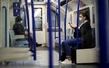 Commuters wear face-masks during morning rush hour on the Victoria Line of the London Underground in central London on October 16, 2020 (Tolga Akmen / AFP)
