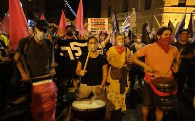 Protesters play drums during a demonstration against Prime Minister Benjamin Netanyahu near his residence in Jerusalem on October 17, 2020. (Menahem Kahana/AFP)