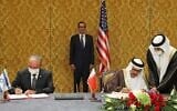 The head of the Israeli delegation, National Security adviser Meir Ben Shabbat (L), and Bahraini Foreign Minister Abdullatif bin Rashid Al-Zayani, sign the Israel-Bahrain accord formalizing diplomatic relations, in the Bahraini capital Manama, on October 18, 2020. US Treasury Secretary Steve Mnuchin (C) looks on. (Ronen Zvulun/Pool/AFP)
