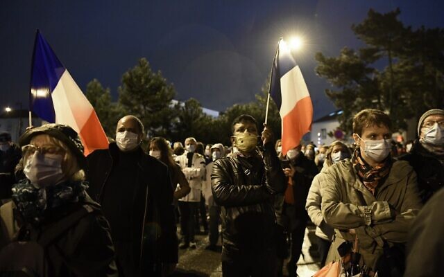 People attend the 'Marche Blanche' in Conflans-Sainte-Honorine, northwest of Paris, on October 20, 2020, in solidarity after a teacher was beheaded for showing pupils cartoons of the Prophet Muhammad. (Photo by Bertrand GUAY / AFP) People attend the 'Marche Blanche' in Conflans-Sainte-Honorine, northwest of Paris, on October 20, 2020, in solidarity after a teacher was beheaded for showing pupils cartoons of the Prophet Muhammad. (Photo by Bertrand GUAY / AFP)