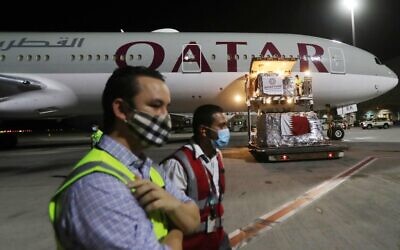 Supplies to tackle the coronavirus pandemic donated by the Qatar Fund for Development are loaded onto a Qatar Airways flight to Kigali in Rwanda at Doha's Hamad International Airport, April 28, 2020. (Photo by KARIM JAAFAR / AFP)
