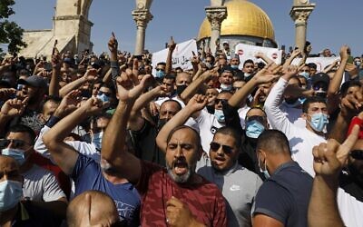 Palestinians gesture during a protest against comments by French President Emmanuel Macron defending cartoons of the Prophet Muhammad, at the Temple Mount in the Old City of Jerusalem, on October 30, 2020. (Ahmad GHARABLI / AFP)