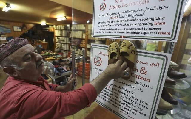 Palestinian shoemaker Imad Mohammad displays his handcrafted footwear stamped with the names of the US and french Presidents in Arabic calligraphy, at his shop in the West Bank city of Ramallah, on October 30, 2020. (Abbas Momani/AFP) Palestinian shoemaker Imad Mohammad displays his handcrafted footwear stamped with the names of the US and french Presidents in Arabic calligraphy, at his shop in the West Bank city of Ramallah, on October 30, 2020. (Abbas Momani/AFP)