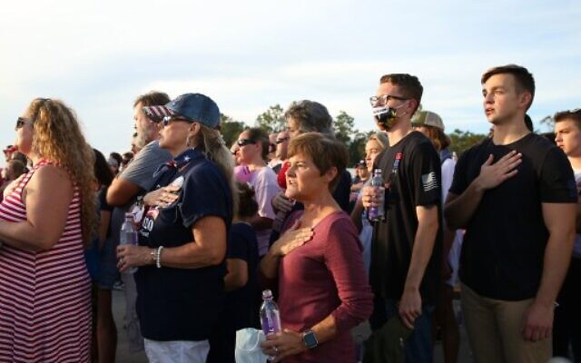 Supporters stand for the national anthem before a rally for US President Donald Trump on October 23, 2020 in Pensacola, Florida. (Jonathan Bachman/Getty Images/AFP) Supporters stand for the national anthem before a rally for US President Donald Trump on October 23, 2020 in Pensacola, Florida. (Jonathan Bachman/Getty Images/AFP)