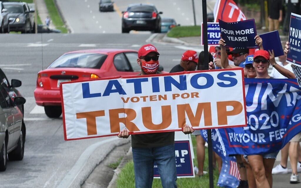 Illustrative: People hold placards after US Vice President Mike Pence addressed supporters at a Latinos for Trump campaign rally at Central Christian University in Orlando, Florida, on October 10, 2020. (Paul Hennessy/NurPhoto via Getty Images/ via JTA)