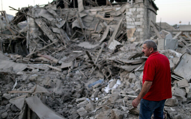 A local resident examines the ruins of a residential house destroyed in a shelling attack in the disputed Caucasus Mountains territory of Nagorno-Karabakh. (Sergei Bobylev/TASS via Getty Images) A local resident examines the ruins of a residential house destroyed in a shelling attack in the disputed Caucasus Mountains territory of Nagorno-Karabakh. (Sergei Bobylev/TASS via Getty Images)