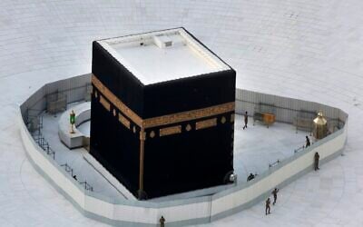 Saudi policemen guard the the Kaaba, the cubic building at the Grand Mosque, in the Muslim holy city of Mecca, Saudi Arabia, March 6, 2020. (Amr Nabil/AP)