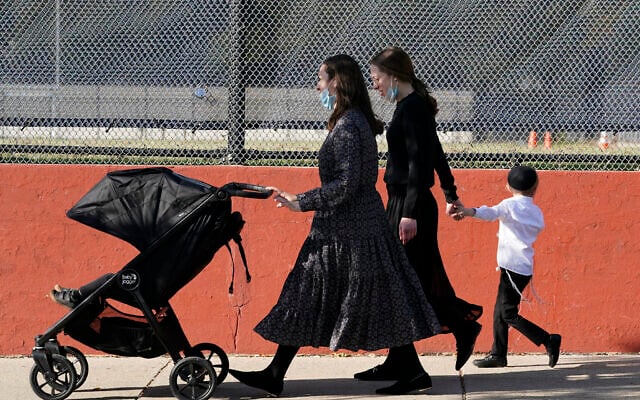 In this October 4, 2020, file photo, two women walk with children during the Jewish holiday of Sukkot in the Borough Park neighborhood of the Brooklyn borough of New York. (AP/Kathy Willens) In this October 4, 2020, file photo, two women walk with children during the Jewish holiday of Sukkot in the Borough Park neighborhood of the Brooklyn borough of New York. (AP/Kathy Willens)