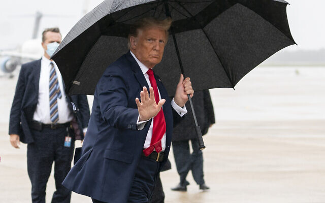 US President Donald Trump boards Air Force One for a campaign rally in Sanford, Fla., Monday, Oct. 12, 2020, in Andrews Air Force Base, Md. (AP Photo/Evan Vucci) US President Donald Trump boards Air Force One for a campaign rally in Sanford, Fla., Monday, Oct. 12, 2020, in Andrews Air Force Base, Md. (AP Photo/Evan Vucci)
