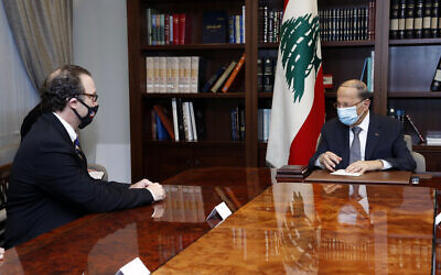 In this photo released by Lebanon's official government photographer Dalati Nohra, Lebanese President Michel Aoun, right, meets with US Assistant Secretary of State for Near Eastern Affairs David Schenker at the Presidential Palace in Baabda, east of Beirut, Lebanon, Friday, Oct. 16, 2020. (Dalati Nohra/Lebanese Government via AP)