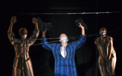 Actresses of the Jewish State Theater, wearing face masks for protection against COVID-19 infection, perform during the rehearsals for the premiere of the "The Beautiful Days of My Youth" play, based on the diary of Romanian Jewish Holocaust survivor Ana Novac, in Bucharest, October 15, 2020. (AP Photo/Andreea Alexandru)