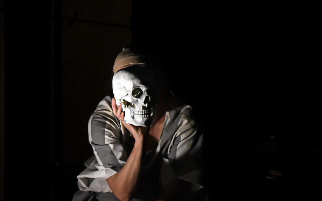 Luana Stoica of the Jewish State Theater performs, wearing a face masks for protection against COVID-19 infection, during the rehearsals for the premiere of the "The Beautiful Days of My Youth" play, based on the diary of Romanian Jewish Holocaust survivor Ana Novac, in Bucharest, October 15, 2020. (AP Photo/Andreea Alexandru)