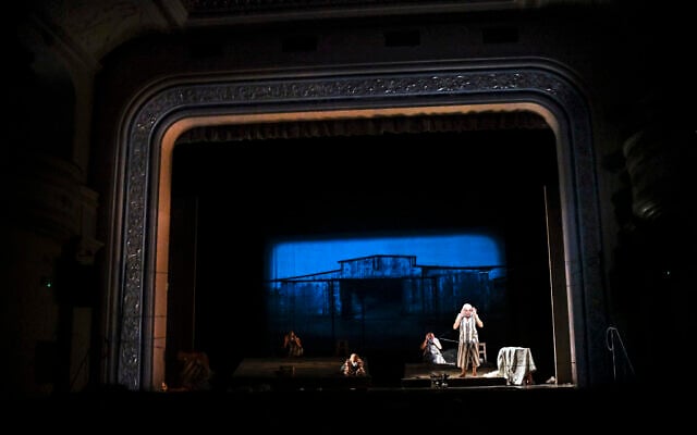 Actresses of the Jewish State Theater, wearing face masks for protection against the COVID-19 infection, perform during the rehearsals for the premiere of the "The Beautiful Days of My Youth" play, based on the diary of Romanian Jewish Holocaust survivor Ana Novac, in Bucharest, October 15, 2020. (AP Photo/Andreea Alexandru)