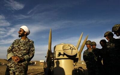 An Iranian clergyman stands next to missiles and army troops, during a maneuver, in an undisclosed location in Iran, November 13, 2012. (Majid Asgaripour/ Mehr News Agency via AP/ File)