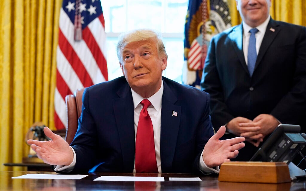 President Donald Trump listens while on a phone call with the leaders of Sudan and Israel, in the Oval Office of the White House, Friday, Oct. 23, 2020, in Washington. Trump announced that the two countries have agreed to make peace. (AP Photo/Alex Brandon) President Donald Trump listens while on a phone call with the leaders of Sudan and Israel, in the Oval Office of the White House, Friday, Oct. 23, 2020, in Washington. Trump announced that the two countries have agreed to make peace. (AP Photo/Alex Brandon)