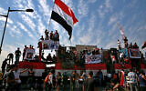Anti-government protesters gather on the closed Joumhouriya Bridge that leads to the Green Zone government areas in Baghdad, Iraq, October 25, 2020. (AP Photo/Khalid Mohammed)