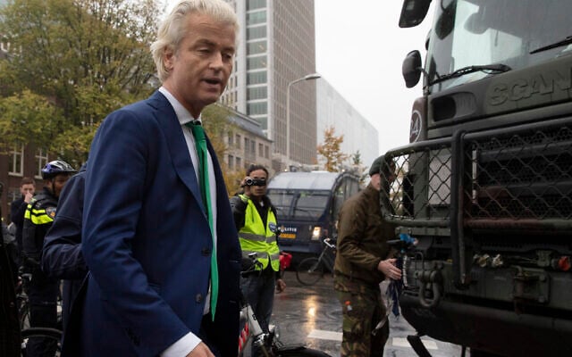 In this photo dated October 16, 2019, Dutch far-right leader Geert Wilders passes army trucks blocking the roads to prevent protesting farmers from reaching parliament in The Hague, Netherlands (AP Photo/Peter Dejong) In this photo dated October 16, 2019, Dutch far-right leader Geert Wilders passes army trucks blocking the roads to prevent protesting farmers from reaching parliament in The Hague, Netherlands (AP Photo/Peter Dejong)