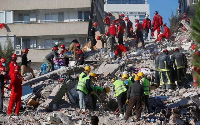Members of rescue services search for survivors in the debris of a collapsed building in Izmir, Turkey, October 31, 2020. (AP Photo/Darko Bandic) Members of rescue services search for survivors in the debris of a collapsed building in Izmir, Turkey, October 31, 2020. (AP Photo/Darko Bandic)