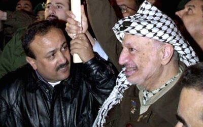 File - Late Palestinian Authority President Yasser Arafat, right, and then-Fatah leader Marwan Barghouti, in the West Bank seat of the PA, Ramallah, December 31, 2001. (AP Photo/Mohammed Rawas)