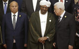 Former Sudanese President Omar al Bashir, center, confers with Palestinian Authority President Mahmoud Abbas, right, as Yemen's President Abdo Rabbo Mansour Hadi looks on as they prepare for a photo session at the extraordinary Organization of Islamic Cooperation (OIC) summit on Palestinian issues in Jakarta, Indonesia, Monday, March 7, 2016. (AP Photo/Dita Alangkara)