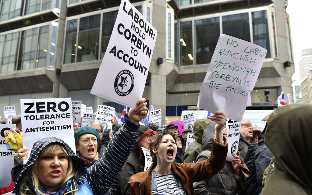 Illustrative: Protesters chant slogans during a demonstration organized by the Campaign Against Antisemitism against alleged prejudice in the Labour Party, amid a row over the party's handling of claims of anti-Semitism, outside the Labour Party headquarters, in London, Sunday April 8, 2018. (Dominic Lipinski/PA via AP) Illustrative: Protesters chant slogans during a demonstration organized by the Campaign Against Antisemitism against alleged prejudice in the Labour Party, amid a row over the party's handling of claims of anti-Semitism, outside the Labour Party headquarters, in London, Sunday April 8, 2018. (Dominic Lipinski/PA via AP)