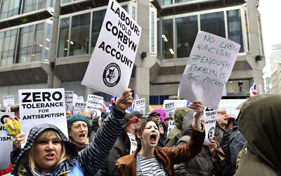 Illustrative: Protesters chant slogans during a demonstration organized by the Campaign Against Antisemitism against alleged prejudice in the Labour Party, amid a row over the party's handling of claims of anti-Semitism, outside the Labour Party headquarters, in London,  Sunday April 8, 2018. (Dominic Lipinski/PA via AP)