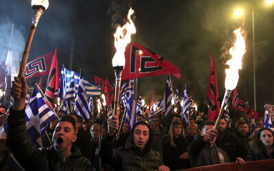 Supporters of Greece's extreme right Golden Dawn raise torches during a rally in Athens, on February 2, 2019. (AP Photo/Yorgos Karahalis)