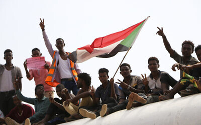 Sudanese pro-democracy supporters celebrate a final power-sharing agreement with the ruling military council August 17, 2019, in the capital, Khartoum. (AP)