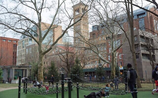 Family members play in Washington Square Park in front of New York University on March 11, 2020, in New York. (AP Photo/Kevin Hagen) Family members play in Washington Square Park in front of New York University on March 11, 2020, in New York. (AP Photo/Kevin Hagen)