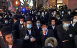 Illustrative: Hundreds of mourners gather in the Brooklyn borough of New York, Tuesday, April 28, 2020, to observe a funeral for Rabbi Chaim Mertz, a Hasidic Orthodox leader whose death was reportedly tied to the coronavirus. (Peter Gerber via AP)