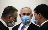 Prime Minister Benjamin Netanyahu, with his lawyers in the courtroom, as his corruption trial opens at the Jerusalem District Court, May 24, 2020. (Ronen Zvulun/ Pool Photo via AP)