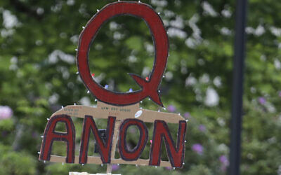 A person carries a sign supporting QAnon at a protest rally in Olympia, Washington, May 14, 2020. (Ted S. Warren/AP)