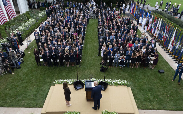 US President Donald Trump, center, stands with Judge Amy Coney Barrett as they arrive for a news conference to announce Barrett as his nominee to the Supreme Court, in the Rose Garden at the White House in Washington, Sept. 26, 2020. (AP Photo/Alex Brandon) US President Donald Trump, center, stands with Judge Amy Coney Barrett as they arrive for a news conference to announce Barrett as his nominee to the Supreme Court, in the Rose Garden at the White House in Washington, Sept. 26, 2020. (AP Photo/Alex Brandon)