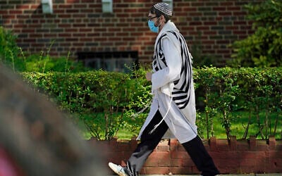An Orthodox Jewish man walks through the Midwood neighborhood of Brooklyn on Yom Kippur, Sept. 28, 2020. (AP Photo/Kathy Willens)