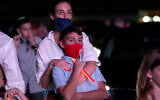 Illustrative: A woman stands with her son during a Yom Kippur service hosted by the Aventura Turnberry Jewish Center, during the coronavirus pandemic, Monday, Sept. 28, 2020, at the Dezerland Park drive-in theatre in North Miami, Fla. (AP Photo/Lynne Sladky)