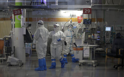 Medical professionals in full protective equipment work in in the critical care coronavirus unit, which was built in an underground parking garage at Sheba Medical center in Ramat Gan, September 30, 2020, amid a spike in COVID-19 cases. (AP Photo/Maya Alleruzzo)