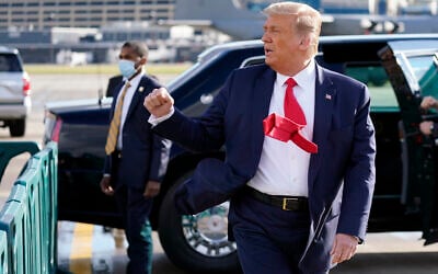 US President Donald Trump gestures to supporters as he arrives at Minneapolis Saint Paul International Airport on September 30, 2020, in Minneapolis. (AP/Alex Brandon)