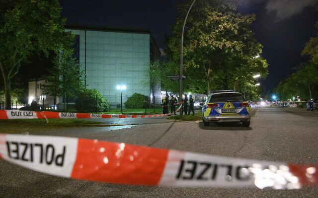 In this Oct. 4, 2020, photo police officers stand at the cordoned-off crime scene outside the synagogue in Hamburg, Germany, that was the scene of an attack (Jonas Walzberg/dpa via AP) In this Oct. 4, 2020, photo police officers stand at the cordoned-off crime scene outside the synagogue in Hamburg, Germany, that was the scene of an attack (Jonas Walzberg/dpa via AP)