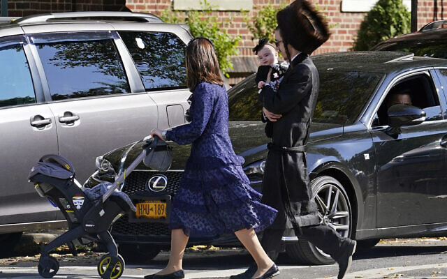 In this October 4, 2020, photo, an Orthodox Jewish family crosses a street during the Jewish holiday of Sukkot in the Borough Park neighborhood in the Brooklyn borough of New York. (AP Photo/Kathy Willens) In this October 4, 2020, photo, an Orthodox Jewish family crosses a street during the Jewish holiday of Sukkot in the Borough Park neighborhood in the Brooklyn borough of New York. (AP Photo/Kathy Willens)