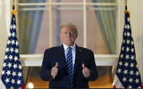 US President Donald Trump gives thumbs up on the Blue Room Balcony upon returning to the White House Monday, Oct. 5, 2020, in Washington, after leaving Walter Reed National Military Medical Center, in Bethesda, Maryland. (AP Photo/Alex Brandon)