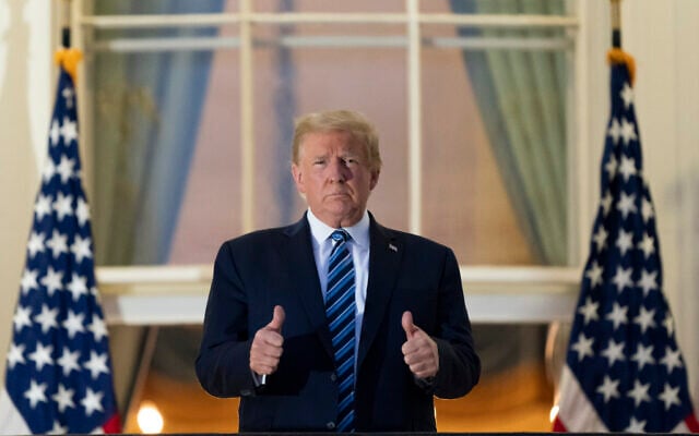 US President Donald Trump gives thumbs up on the Blue Room Balcony upon returning to the White House Monday, Oct. 5, 2020, in Washington, after leaving Walter Reed National Military Medical Center, in Bethesda, Maryland. (AP Photo/Alex Brandon) US President Donald Trump gives thumbs up on the Blue Room Balcony upon returning to the White House Monday, Oct. 5, 2020, in Washington, after leaving Walter Reed National Military Medical Center, in Bethesda, Maryland. (AP Photo/Alex Brandon)