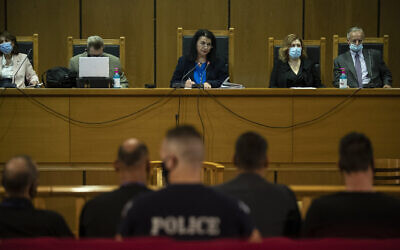 Judge Maria Lepenioti, center, delivers a verdict ruling that the far-right Golden Dawn party is operating as a criminal organization, in a court in Athens, Greece, October 7, 2020. (AP Photo/Petros Giannakouris)