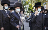 Illustrative: Members of the ultra-Orthodox community gather to listen in on an interview with a journalist, October 7, 2020, in the Borough Park neighborhood of the Brooklyn borough of New York. (AP Photo/John Minchillo)