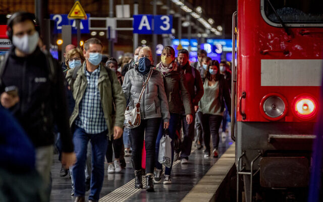 Passengers wear face masks as they leave a train in the central train station in Frankfurt, Germany, October 8, 2020. (AP Photo/Michael Probst) Passengers wear face masks as they leave a train in the central train station in Frankfurt, Germany, October 8, 2020. (AP Photo/Michael Probst)