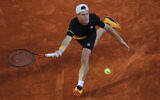 Argentina's Diego Schwartzman plays a shot against Spain's Rafael Nadal in the semifinal match of the French Open tennis tournament at the Roland Garros stadium in Paris, France, Oct. 9, 2020. (AP Photo/Christophe Ena)