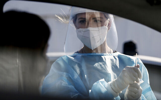 A medical staffer performs tests for the coronavirus at a drive-through at Rome's Leonardo Da Vinci airport, Friday, Oct. 9, 2020. Italy’s new confirmed caseload Friday passed 5,372, the highest levels since March. (Cecilia Fabiano/LaPresse via AP) A medical staffer performs tests for the coronavirus at a drive-through at Rome's Leonardo Da Vinci airport, Friday, Oct. 9, 2020. Italy’s new confirmed caseload Friday passed 5,372, the highest levels since March. (Cecilia Fabiano/LaPresse via AP)
